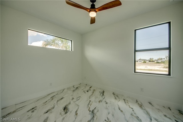 unfurnished room with light tile patterned flooring, a healthy amount of sunlight, and ceiling fan