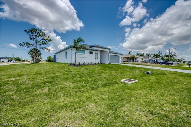 ranch-style house featuring a garage and a front lawn