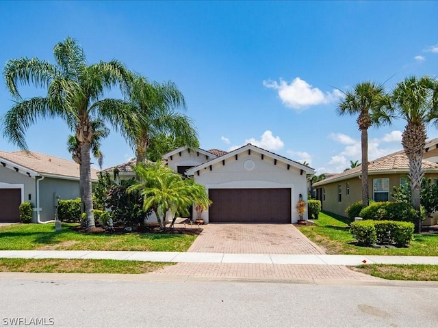 mediterranean / spanish house with a front yard and a garage