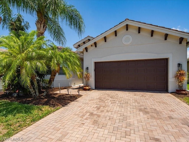 mediterranean / spanish home with a garage