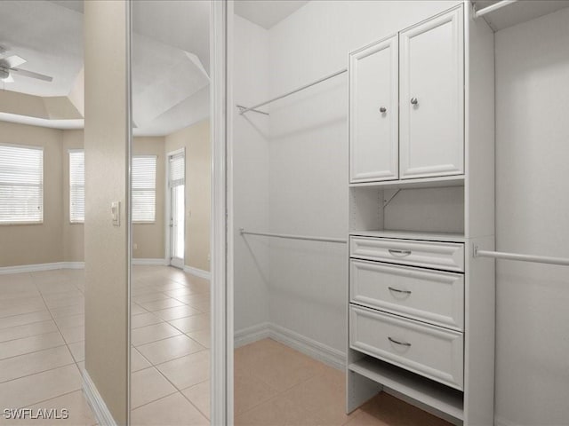 spacious closet featuring ceiling fan and light tile patterned floors