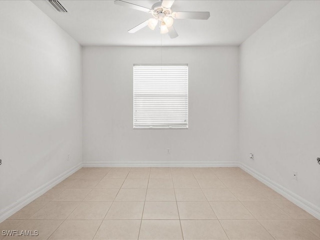 tiled spare room featuring ceiling fan