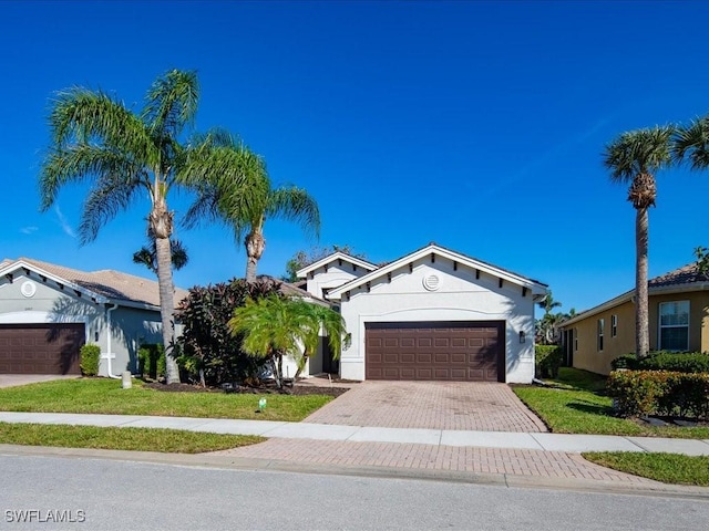 view of front of property featuring a garage and a front yard