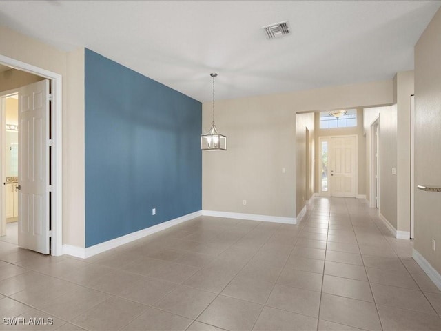 spare room featuring light tile patterned flooring