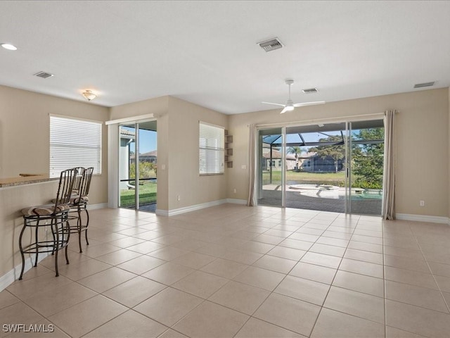 tiled empty room with ceiling fan