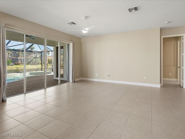 tiled empty room featuring ceiling fan