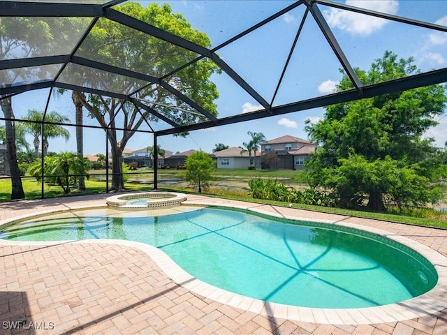 view of pool featuring an in ground hot tub, a lanai, and a patio