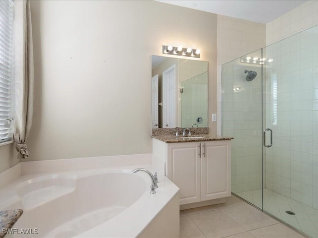 bathroom featuring vanity, tile patterned floors, and shower with separate bathtub