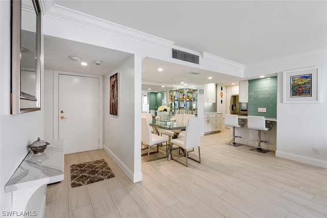 entryway featuring crown molding