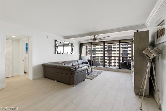 living room with ornamental molding, a wealth of natural light, ceiling fan, and light hardwood / wood-style flooring