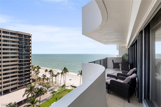 balcony with a water view and a beach view