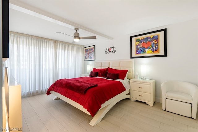 bedroom with ceiling fan and beam ceiling