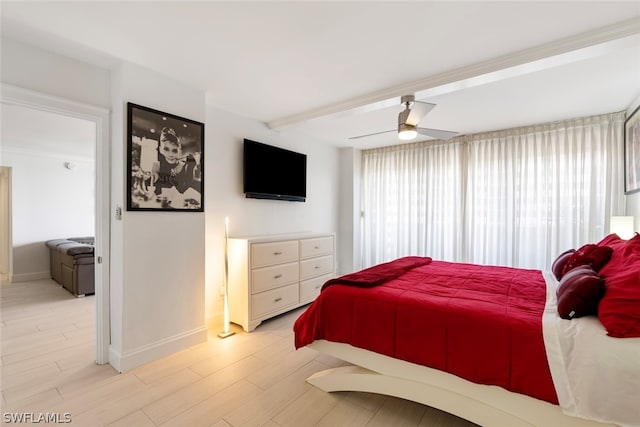 bedroom with ceiling fan, beam ceiling, and light hardwood / wood-style floors