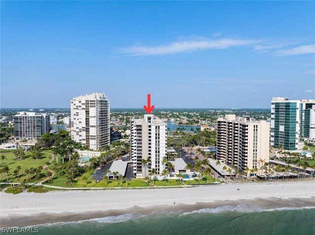 birds eye view of property featuring a water view and a view of the beach