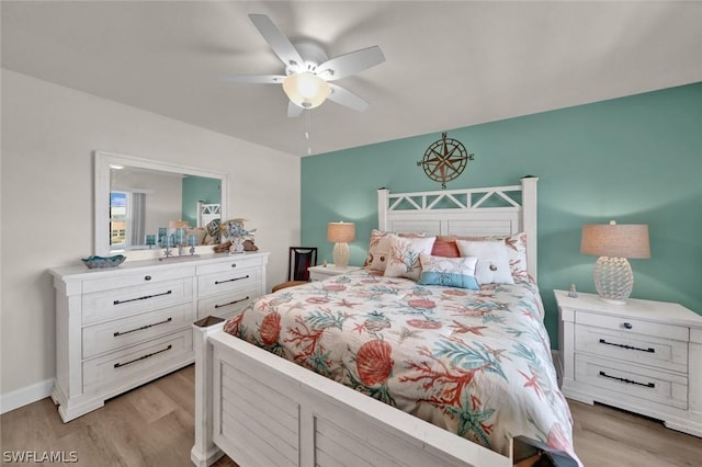 bedroom featuring a ceiling fan, baseboards, and light wood finished floors