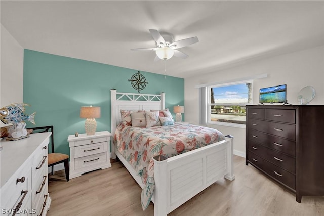 bedroom with light wood-style floors, ceiling fan, and baseboards