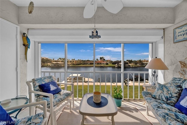 sunroom / solarium featuring a water view