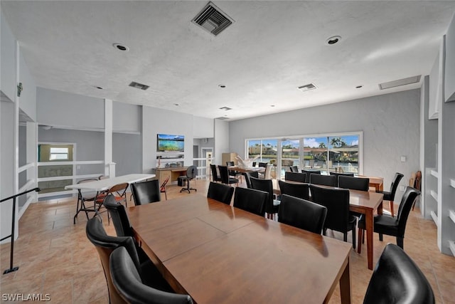 dining space featuring light tile patterned floors and visible vents