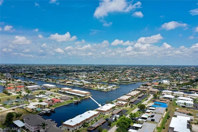 drone / aerial view featuring a residential view and a water view