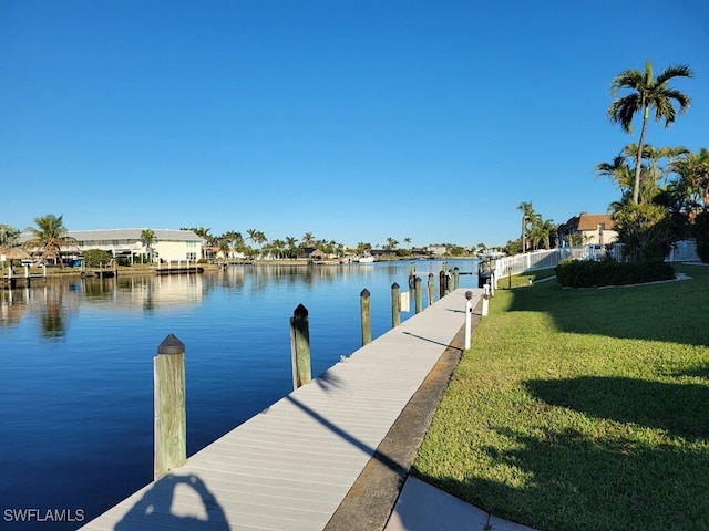 dock area with a water view and a yard