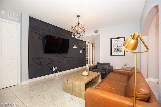 living room featuring an inviting chandelier and light tile floors