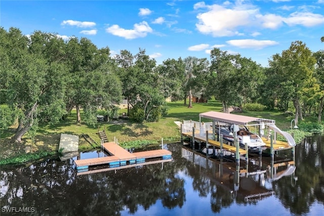 dock area with a lawn and a water view