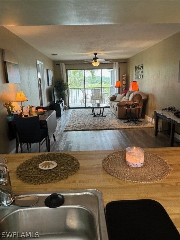 living room with hardwood / wood-style flooring and ceiling fan