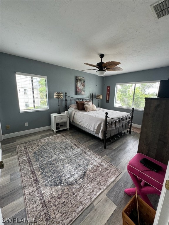 bedroom featuring dark hardwood / wood-style flooring and ceiling fan