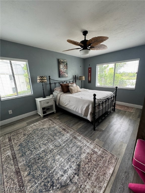 bedroom featuring dark hardwood / wood-style flooring and ceiling fan