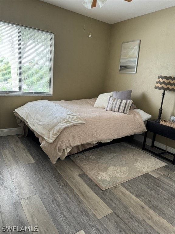 bedroom featuring ceiling fan and hardwood / wood-style flooring