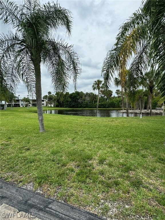 exterior space with a water view and a yard