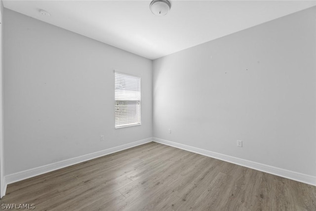 unfurnished room with wood-type flooring