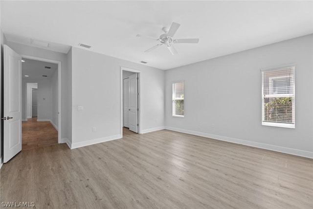 unfurnished bedroom featuring ceiling fan, light hardwood / wood-style floors, and multiple windows