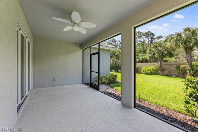 unfurnished sunroom with ceiling fan