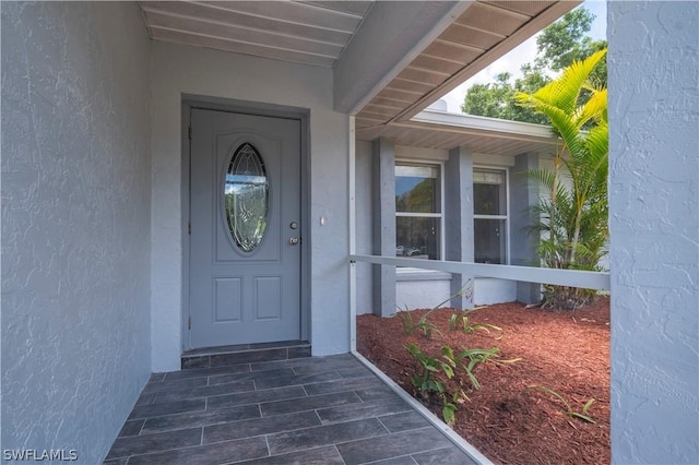 entrance to property with stucco siding