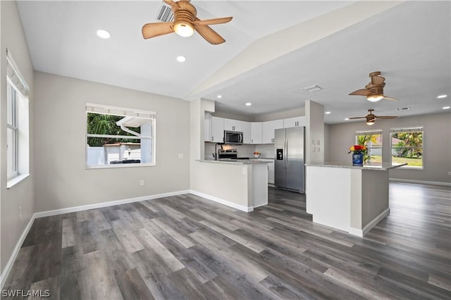 kitchen featuring stainless steel appliances, dark wood-style flooring, backsplash, and baseboards