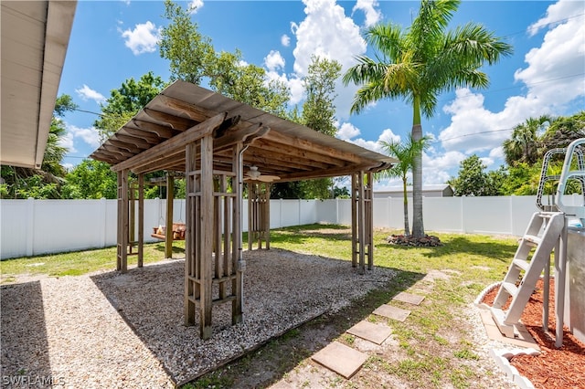 view of yard with a fenced backyard, ceiling fan, and a patio