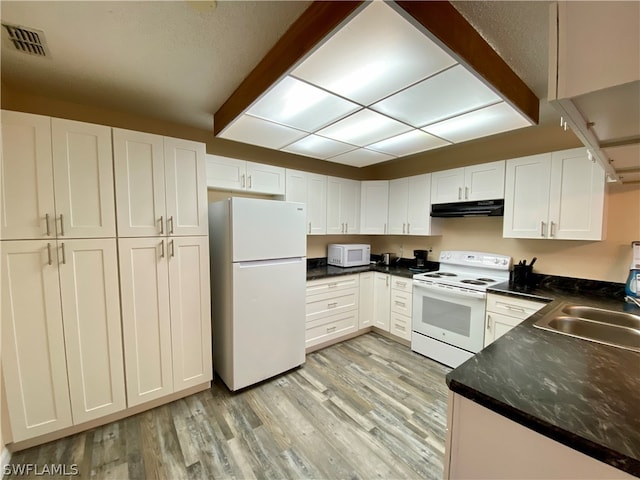 kitchen featuring sink, light hardwood / wood-style flooring, white cabinets, and white appliances