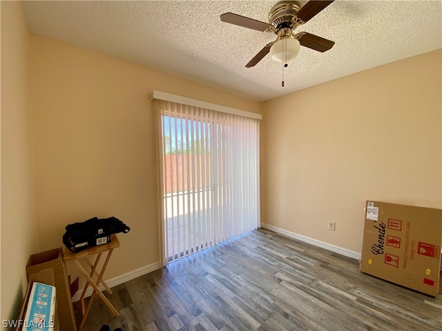 unfurnished room featuring ceiling fan, a textured ceiling, and wood-type flooring