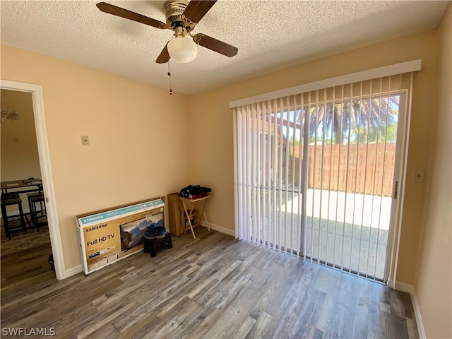 interior space featuring a textured ceiling, ceiling fan, and hardwood / wood-style floors