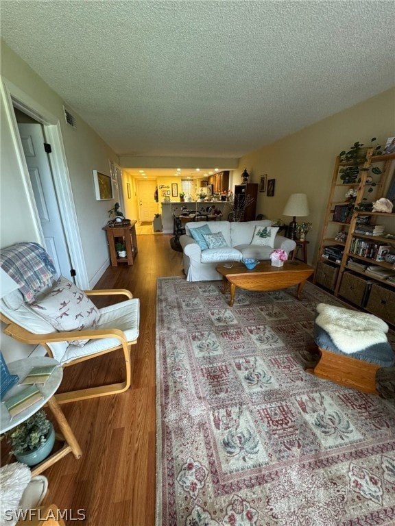 living room featuring a textured ceiling and hardwood / wood-style flooring