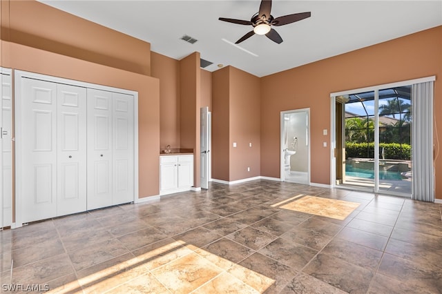 interior space featuring access to outside, ensuite bathroom, sink, and ceiling fan