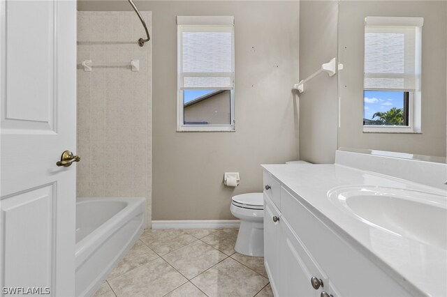 full bathroom featuring tile patterned floors, vanity, tiled shower / bath, and toilet