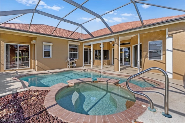 view of swimming pool featuring glass enclosure, area for grilling, an in ground hot tub, and a patio