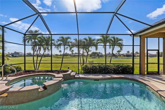 view of pool featuring glass enclosure, an in ground hot tub, and a yard