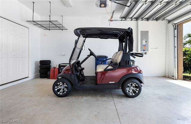 garage with electric panel and a garage door opener