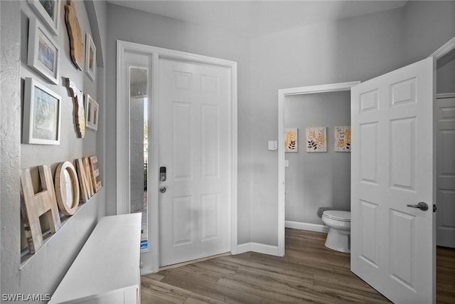 bathroom with hardwood / wood-style floors and toilet