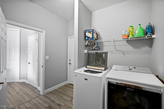 laundry room featuring light wood-type flooring and independent washer and dryer
