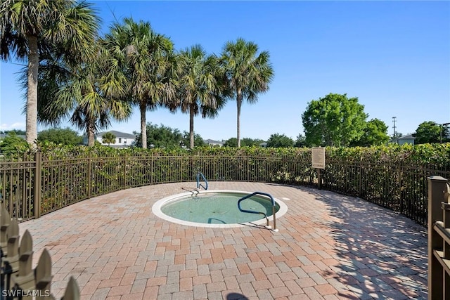 view of pool featuring an in ground hot tub and a patio