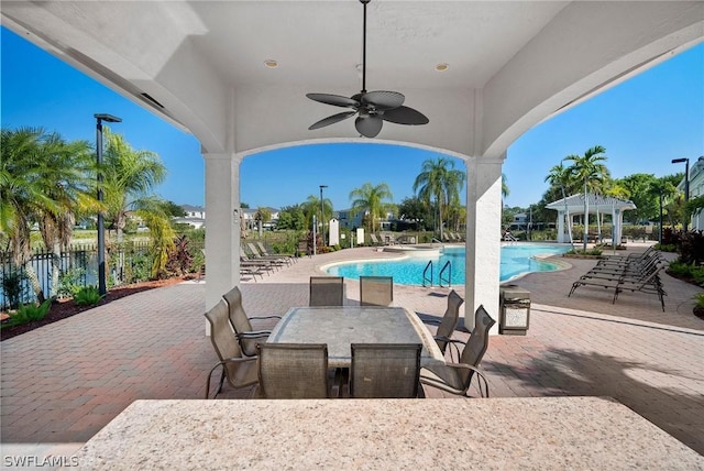 view of pool featuring a gazebo, ceiling fan, and a patio
